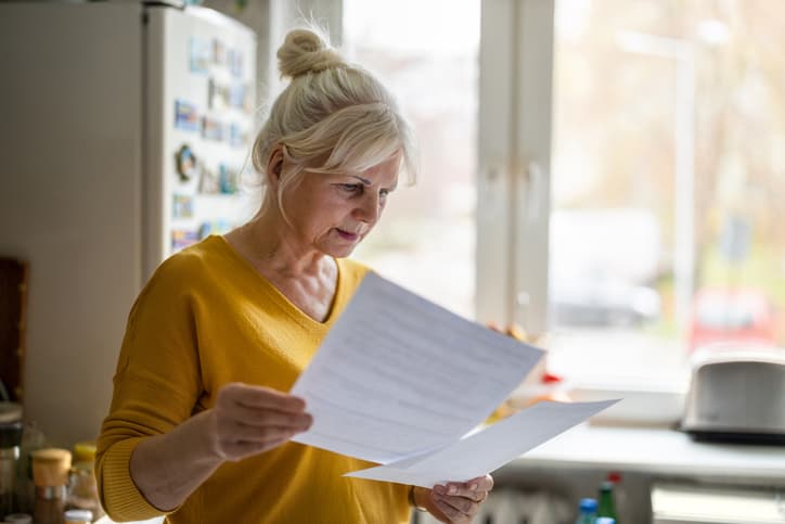 woman reading insurance documents